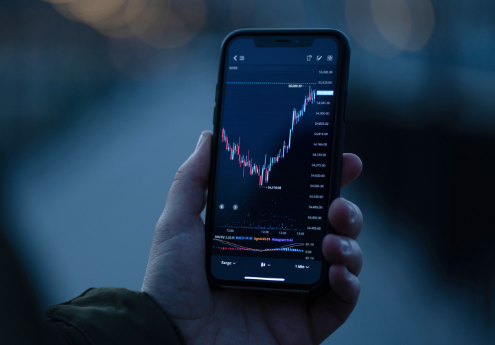 A person using a trading app on their tablet